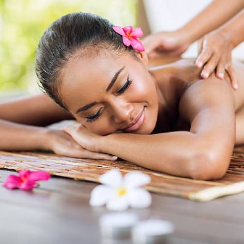 professional masseur doing massage of female back in the beauty salon